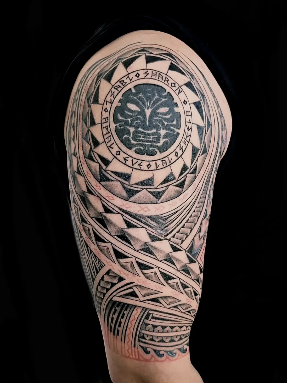 Polynesian half sleeve with a sun medallion